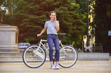 Obraz premium girl with Bicycle talking on the phone