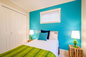 Modern blue bedroom interior in a luxury house with reclaimed wood bedside tables.