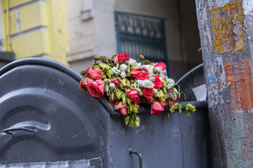 Discarded withered flowers lying in the dustbin