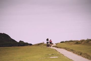 Cyclists on a costal path in Cornwall Vintage Retro Filter.