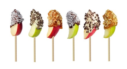 Mixed candy dipped apple slices isolated on a white background