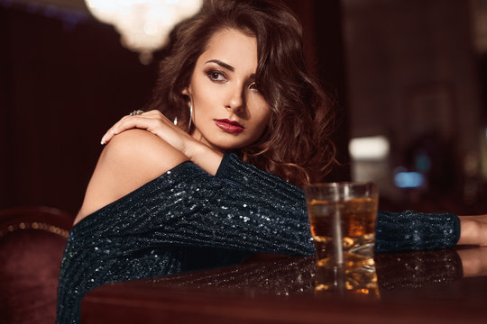 Beauty Young Brunette Woman Sitting At The Bar