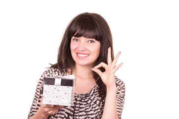 Fototapeta premium beautiful young happy girl holding present wrapped in a box