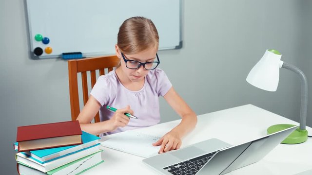 Schoolgirl doing homework in mathematics i her desk
