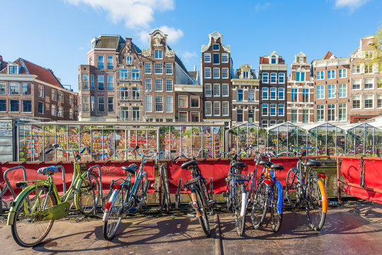 Fototapeta Many bicycle parking near flower market in Amsterdam, Netherlands