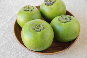 Sapote or black chocolate pudding fruit in wooden bowl
