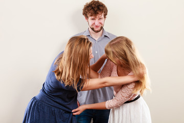 Aggressive mad women fighting over man.