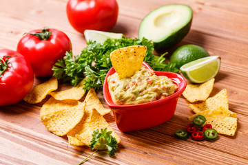 Guacamole with avocado, lime, tomato, and cilantro