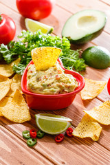 Guacamole with avocado, lime, tomato, and cilantro