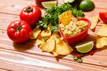 Guacamole with avocado, lime, tomato, and cilantro