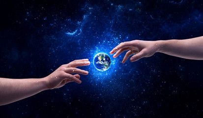 Hands in space touching planet earth