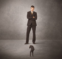 Fototapeta premium Big business man looking at small worker