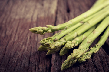  fresh asparagus on wooden table