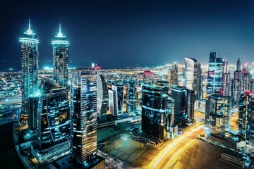 Zelfklevend Fotobehang Midden-Oosten Fantastic view of a big city at night with illuminated modern architecture. Dubai downtown, United Arab Emirates.