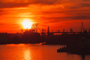 Fototapeta na wymiar Black silhouettes of cranes and ships, Varna port