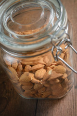 Raw almonds in Glass Jar.