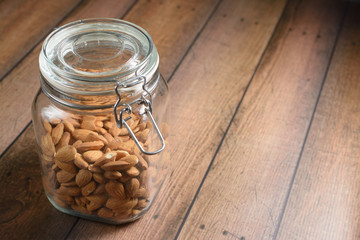 Raw almonds in Glass Jar.