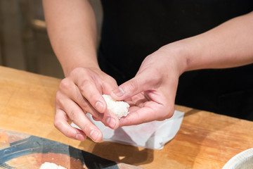 Close up hand of Japanese chef making sushi
