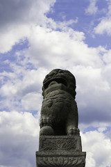 Fototapeta na wymiar Chinese Sculpture Shih tsza on blue sky background in St.Petersburg