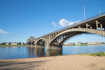 Fototapeta na wymiar The road bridge in Rybinsk, sunny day in july. View from the left bank of the Volga river