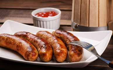 Grilled sausages with beer mug