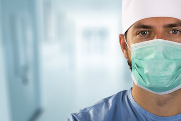 doctor surgeon with face mask standing in the hospital hallway - obrazy, fototapety, plakaty