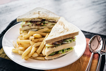 club sandwich snack with french fries on plate
