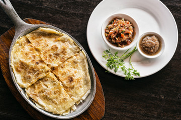 mexican cheese quesadilla with salsa and chilli sauce
