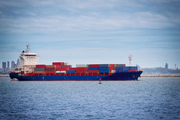 Fototapeta premium commercial container ship with dramatic sky