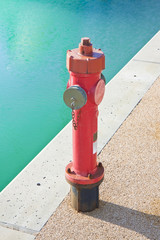 Red fire hydrant on gravel quay - image with copy space