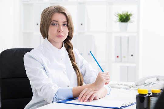 Young woman doctor with braided hair