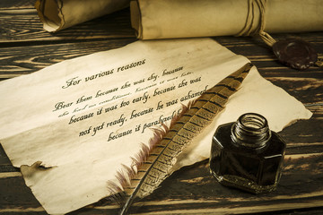 Roll of parchment with a pen and inkwell
