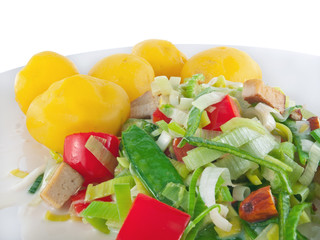 boiled potatoes with tofu, vegetables and almonds in vegan soy cream sauce