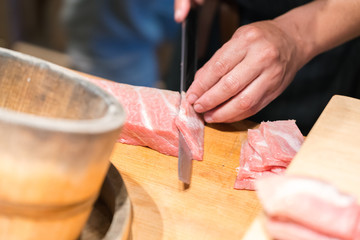 Sushi Chef Cutting Tuna Otoro  (Fatty tuna) Sashimi
