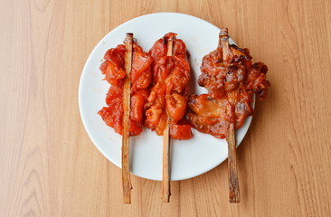 roasted chicken in wooden stick on dish