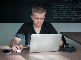 a student is disappointed by a task in his laptop