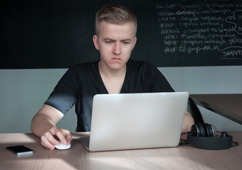 a student is disappointed by a task in his laptop