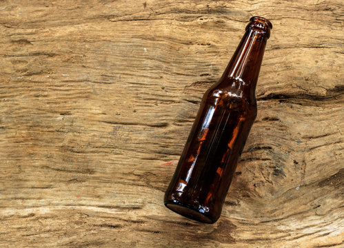 empty Brown beer bottle on wood background