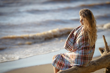 Fototapeta na wymiar Young beautiful girl woman enjoying sunset at stormy sea