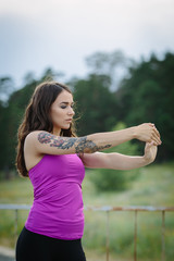 Sporty young woman warming up before running in the city