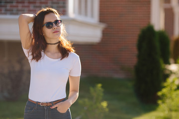 Portrait of serious young teenage woman student girl wearing sunglasses