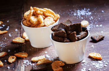 Rye crackers and baguette rusks with salt and spices in white bo