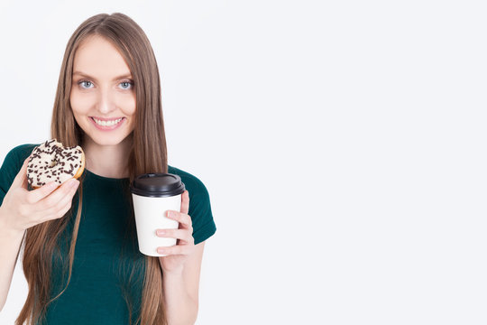 Smiling young lady with donut and coffee