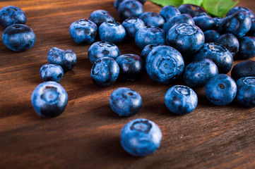Blueberries berries lie on a wooden table.