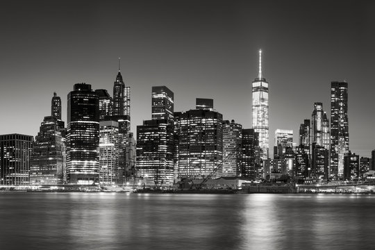 Black & White East River view of Financial District skyscrapers at dusk. Lower Manhattan skyline, New York City