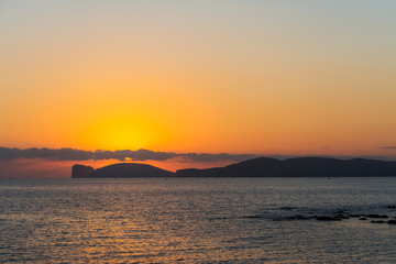 Naklejka premium clouds over Capo Caccia at sunset