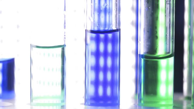 Close up HD video of test tubes. Bright lamps