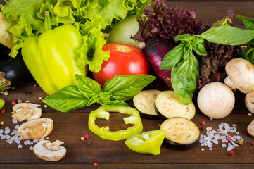 Various fresh vegetables from the garden on a wooden table.
