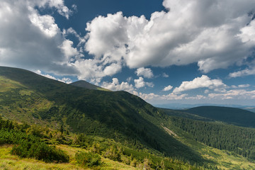 Beautiful mountain landscape. Clouds hid the sun, the shadow of a cloud covered the .