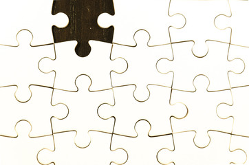 fill the gaps, white jigsaw/puzzle whit one gap, over  black wooden table background, symbol of problem solving